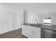 Kitchen island with granite countertop and stainless steel dishwasher at 454 Lake Shore Pkwy, Davenport, FL 33896