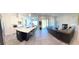 Open floor plan with modern kitchen and adjacent living room at 4749 Riverwalk Dr, St Cloud, FL 34771