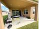 Covered patio with seating area and large backyard at 4749 Riverwalk Dr, St Cloud, FL 34771