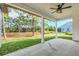 Covered patio overlooking a spacious backyard and wooded area at 4765 Hickory Tree Rd, Saint Cloud, FL 34772