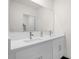 Modern bathroom with a double vanity and large mirror at 399 Talisi Loop, Saint Cloud, FL 34771