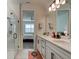 Bathroom with double vanity, walk-in shower, and view into bedroom at 4009 Winding Meadows St, Apopka, FL 32712