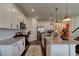 Modern kitchen with white cabinets, granite countertops, and stainless steel appliances at 4009 Winding Meadows St, Apopka, FL 32712
