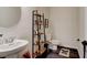 Small bathroom with pedestal sink and stylish storage shelving at 4009 Winding Meadows St, Apopka, FL 32712