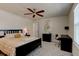 Bright bedroom featuring a built-in workspace and ceiling fan at 4009 Winding Meadows St, Apopka, FL 32712