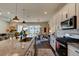 Open kitchen with island, granite countertops and stainless steel appliances at 4009 Winding Meadows St, Apopka, FL 32712