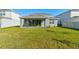 Large backyard with grassy lawn and covered patio at 4009 Winding Meadows St, Apopka, FL 32712