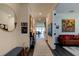 Bright and airy entryway with a large mirror and artwork leading to the living areas at 4009 Winding Meadows St, Apopka, FL 32712
