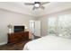 Large bedroom with a dresser, TV, and access to a balcony at 1400 Celebration Ave # 303, Celebration, FL 34747