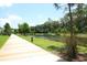 Tranquil lakeside walking path with lush greenery at 1400 Celebration Ave # 303, Celebration, FL 34747