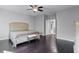 Large bedroom with dark hardwood floors and a ceiling fan at 8077 Pleasant Pine Cir, Winter Park, FL 32792