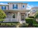 Two-story house with gray exterior, white porch, and landscaping at 8077 Pleasant Pine Cir, Winter Park, FL 32792