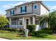 Two-story house with gray siding, white trim, and landscaping at 8077 Pleasant Pine Cir, Winter Park, FL 32792