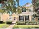 Two-story house with light peach walls, black shutters, and a landscaped yard at 14494 Whittridge Dr, Winter Garden, FL 34787