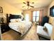 Main bedroom with king bed and access to balcony at 909 Charo Pkwy # 1022, Davenport, FL 33897