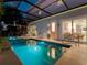 Beautiful screened pool and spa at night. The view shows the house interior and relaxing atmosphere at 4260 S Atlantic Ave, Port Orange, FL 32127