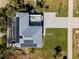 Top-down view of a house with solar panels, pool, and patio at 4260 S Atlantic Ave, Port Orange, FL 32127