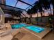 Relaxing screened pool and spa at night with outdoor seating and dining areas at 4260 S Atlantic Ave, Port Orange, FL 32127