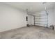 Attached garage with white painted block walls and concrete floor at 1119 Boardwalk Pl, Kissimmee, FL 34747