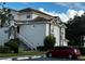 Gray condo building with staircase and parking in front at 14013 Fairway Island Dr # 415, Orlando, FL 32837