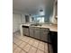 Kitchen with gray cabinets, stainless steel appliances, and a breakfast bar at 14013 Fairway Island Dr # 415, Orlando, FL 32837