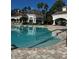 Community pool with surrounding lounge chairs at 14013 Fairway Island Dr # 415, Orlando, FL 32837