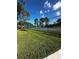 Tennis court with surrounding fence and landscaping at 14013 Fairway Island Dr # 415, Orlando, FL 32837