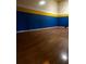 Spacious game room with hardwood floors and blue and yellow walls at 14013 Fairway Island Dr # 415, Orlando, FL 32837