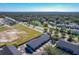 Aerial view showcasing townhomes and a large undeveloped lot at 643 Underwood Cv, Casselberry, FL 32707