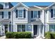 Two-story townhome with gray siding, navy shutters, and a manicured lawn at 643 Underwood Cv, Casselberry, FL 32707