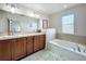 Bathroom with double vanity, soaking tub, and updated fixtures at 643 Underwood Cv, Casselberry, FL 32707