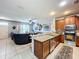 Open concept kitchen features granite island and stainless steel appliances at 643 Underwood Cv, Casselberry, FL 32707