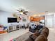 Spacious living room with sectional sofa, kitchen, and staircase at 643 Underwood Cv, Casselberry, FL 32707