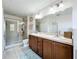 Bathroom with double vanity, large mirror, and shower at 643 Underwood Cv, Casselberry, FL 32707