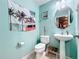 Charming bathroom with teal walls and pedestal sink at 643 Underwood Cv, Casselberry, FL 32707