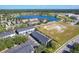 Aerial view showing townhomes, a lake, and surrounding area at 643 Underwood Cv, Casselberry, FL 32707