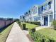 Townhouses with gray exterior, landscaping, and sidewalk at 643 Underwood Cv, Casselberry, FL 32707