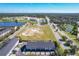 Aerial view of townhomes near a school and large undeveloped lot at 643 Underwood Cv, Casselberry, FL 32707