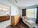 Cozy bedroom with dresser and view of en-suite bathroom at 643 Underwood Cv, Casselberry, FL 32707