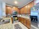 Modern kitchen with wood cabinets and granite countertops at 643 Underwood Cv, Casselberry, FL 32707