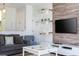 Cozy living room featuring a comfortable sofa, a coffee table, and a large TV at 900 Las Fuentes Dr, Kissimmee, FL 34746
