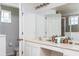 Double sink bathroom with a large mirror, and access to a toilet and shower at 900 Las Fuentes Dr, Kissimmee, FL 34746