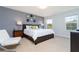 Bright bedroom with king-size bed and ensuite bath at 900 Las Fuentes Dr, Kissimmee, FL 34746