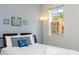 Bright bedroom with a queen bed, window with a view, and beach themed decor at 900 Las Fuentes Dr, Kissimmee, FL 34746