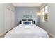 Bright bedroom with a full bed, window with a view, and beach themed decor at 900 Las Fuentes Dr, Kissimmee, FL 34746
