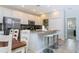 Modern kitchen with white cabinets, stainless steel appliances, and an island with seating at 900 Las Fuentes Dr, Kissimmee, FL 34746