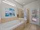 Luxurious bathroom with a soaking tub and walk-in shower at 8832 Macapa Dr, Kissimmee, FL 34747