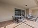 Covered patio with table, chairs, and lounge chairs at 8832 Macapa Dr, Kissimmee, FL 34747