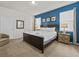 Main bedroom with king-size bed and an ensuite bathroom at 8832 Macapa Dr, Kissimmee, FL 34747