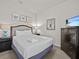 Spacious bedroom with a comfortable queen-size bed and dresser at 8832 Macapa Dr, Kissimmee, FL 34747